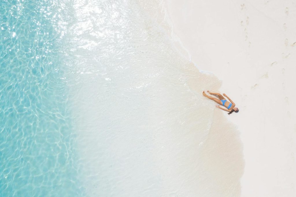 Woman Lying on Seashore